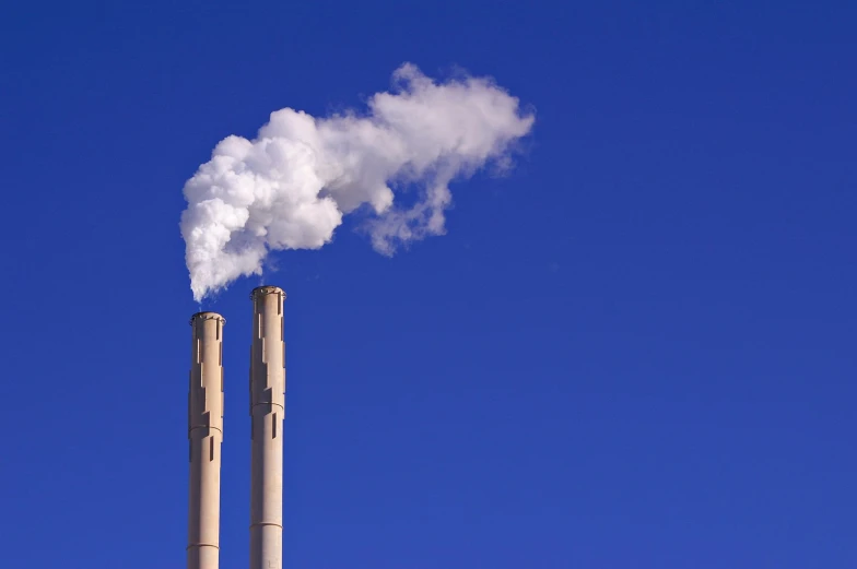 a chimney emitting smoke into a blue sky