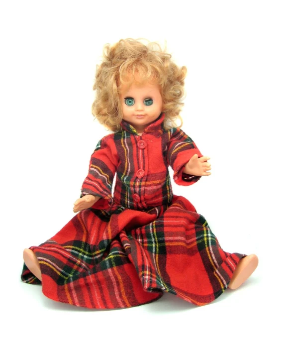 a doll with blonde hair wearing a red dress and holding her legs