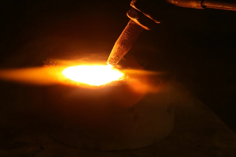 a person welding in on a piece of steel