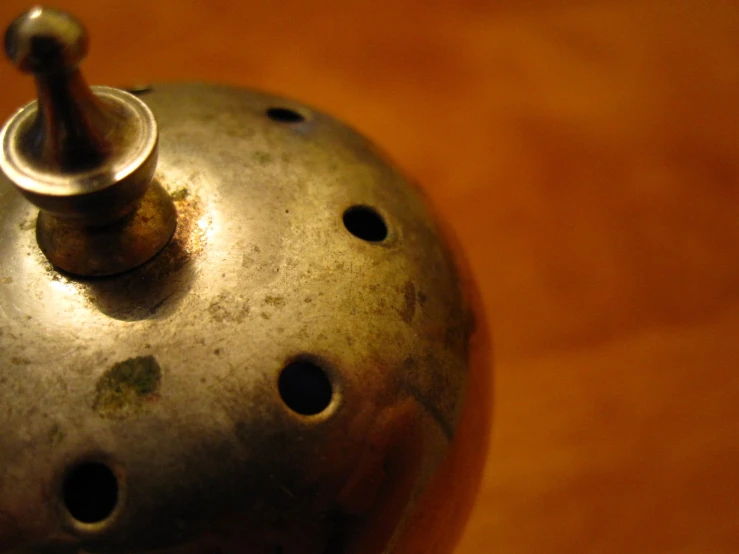 a tea pot with holes on the front and inside