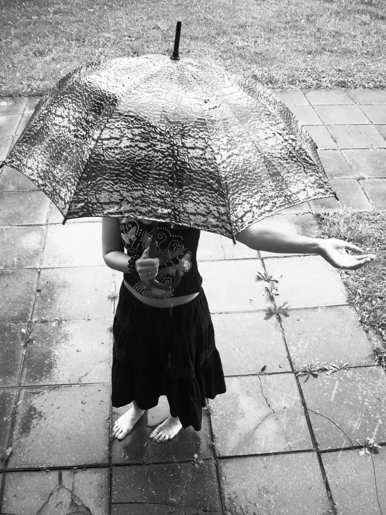 a woman holding an umbrella on a city street