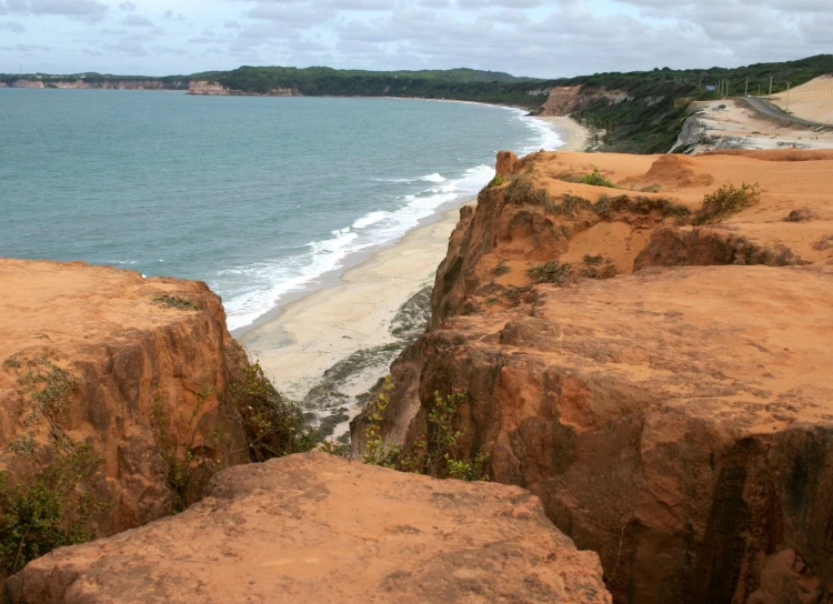 the view from atop a large rock that looks to be overlooking the water