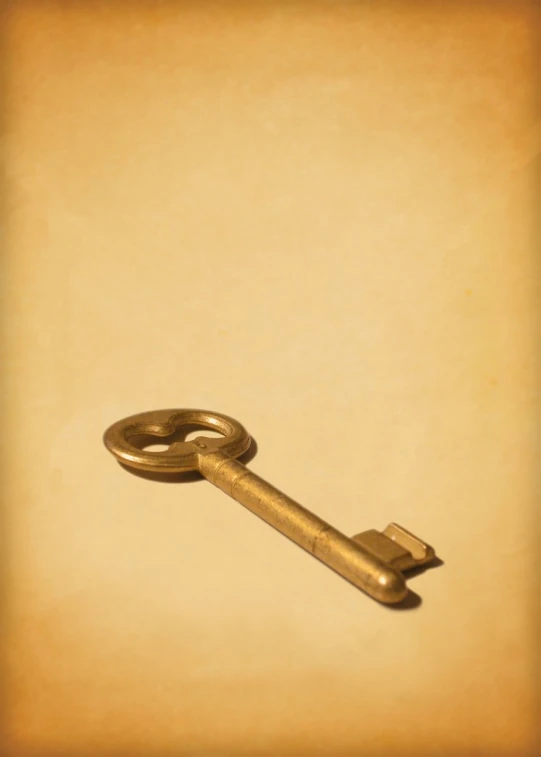 an old key sitting on top of a yellow sheet