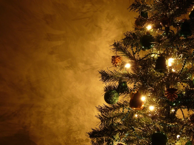 a christmas tree with small lights and ornaments on the tree