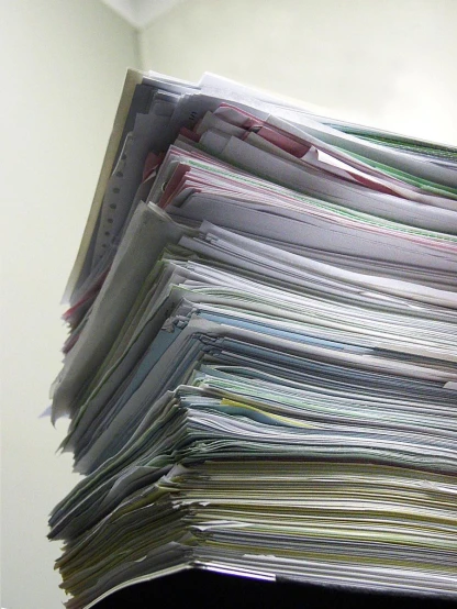the work papers are piled on top of each other