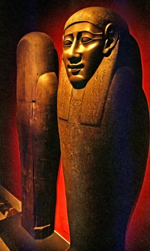 a egyptian sculpture with the body of an egyptian person