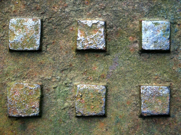 a square cement patch of bricks with various colors on them