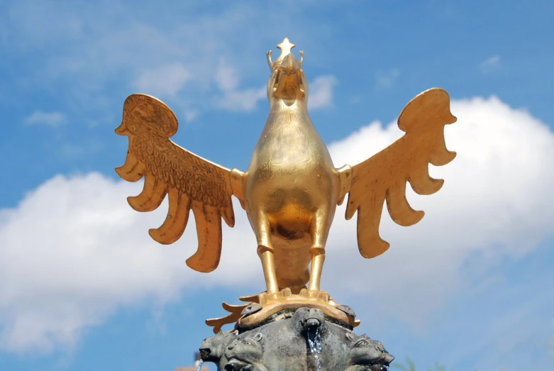 an image of a golden statue of a bird