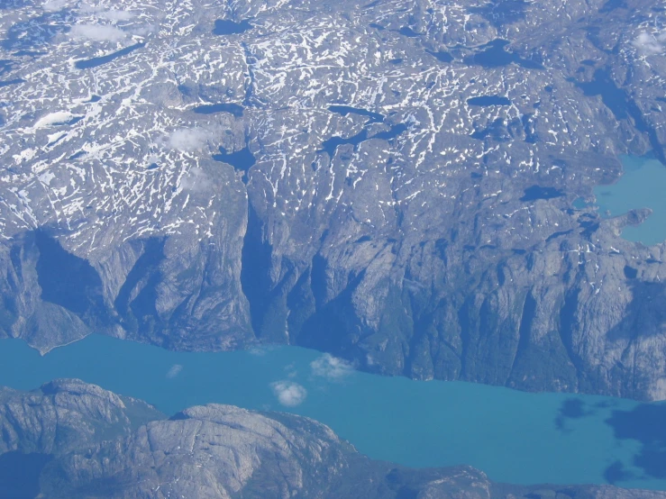 a view from a plane of the mountains and lake below