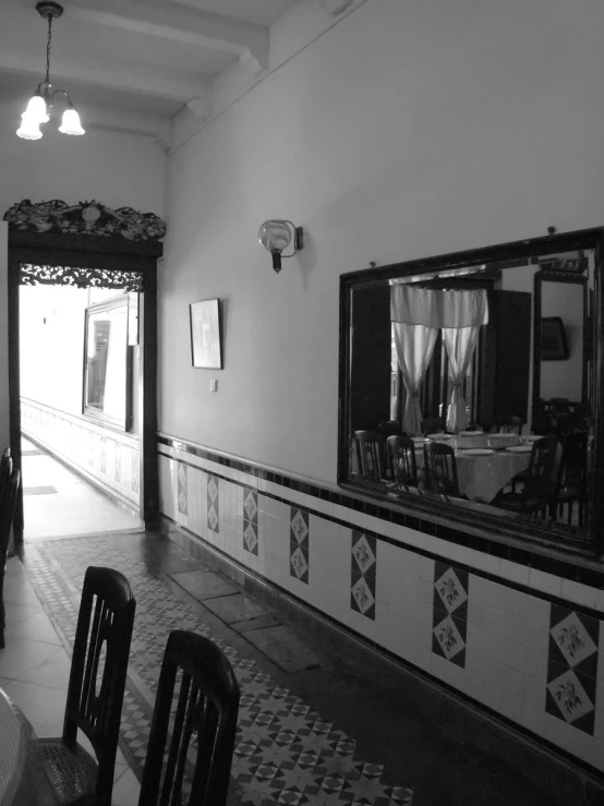 the empty kitchen area of an antique house with the door open
