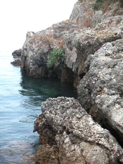 a rocky shore line with lots of water and rocks