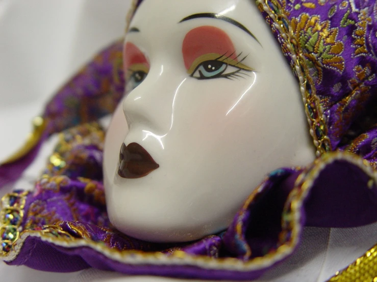 a purple mask with orange, red and gold accents