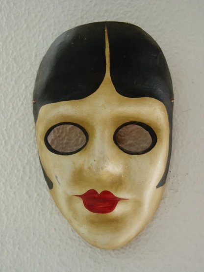 a mask with a yellow, black and red face