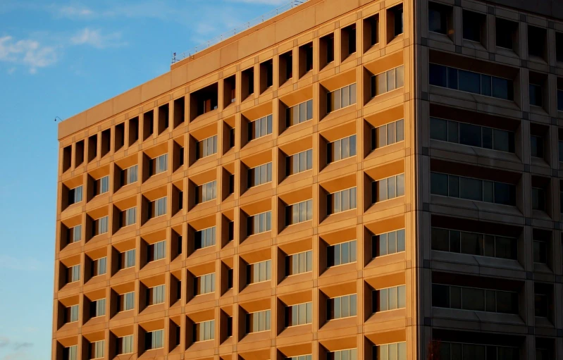 a very tall building in front of a blue sky