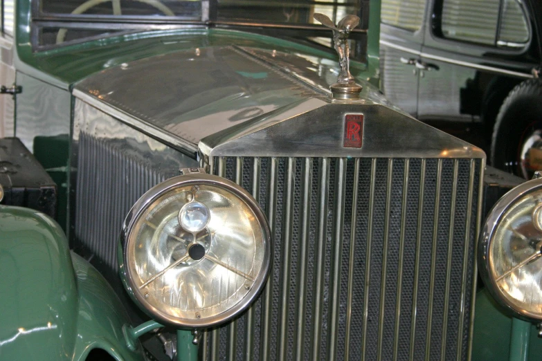 the front grille and headlights of an antique model automobile