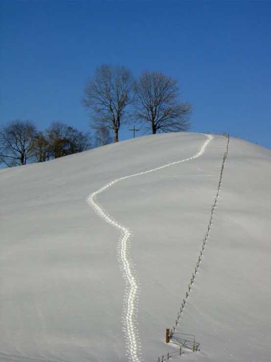 the ski is on a very steep snowy hill