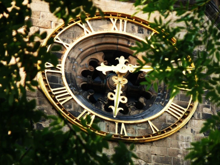 a clock in the face of a building that's made out of metal