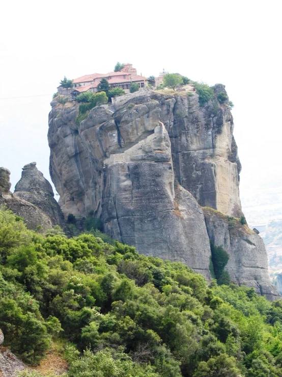 the rock formations and houses are shown on the top of a mountain
