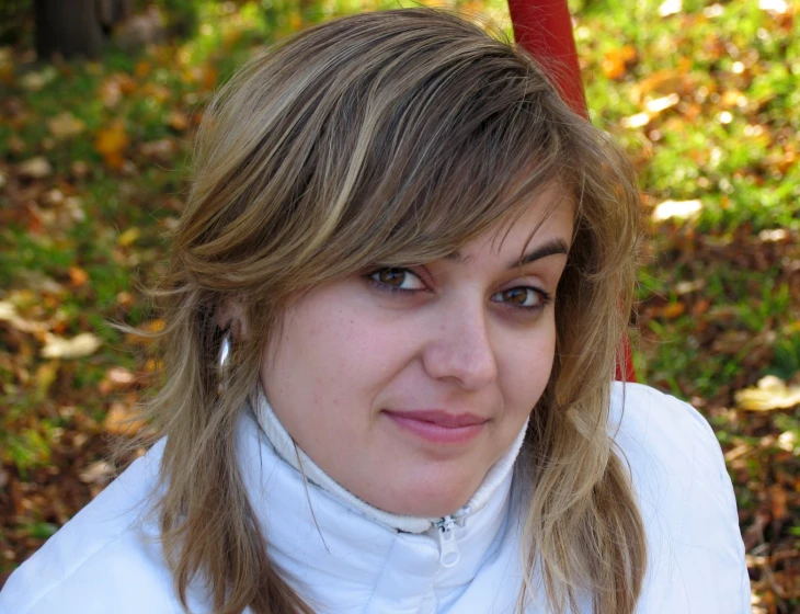 a pretty woman in a white shirt posing for a picture