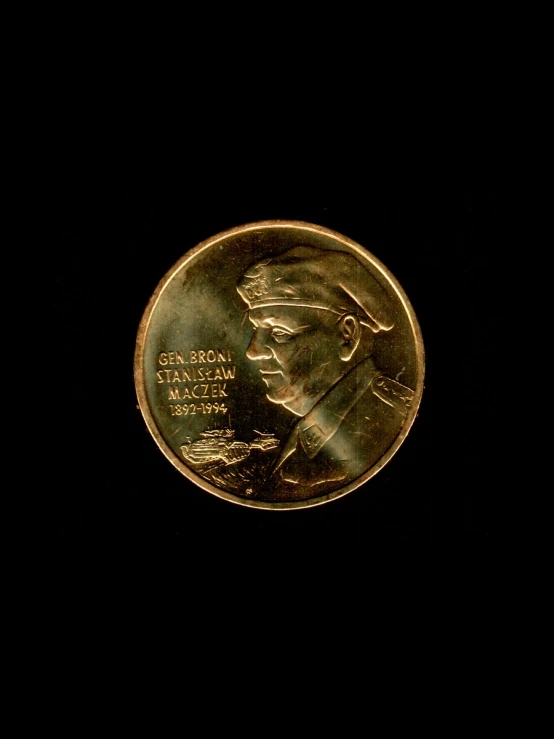 a gold coin in the dark with the image of john lincoln