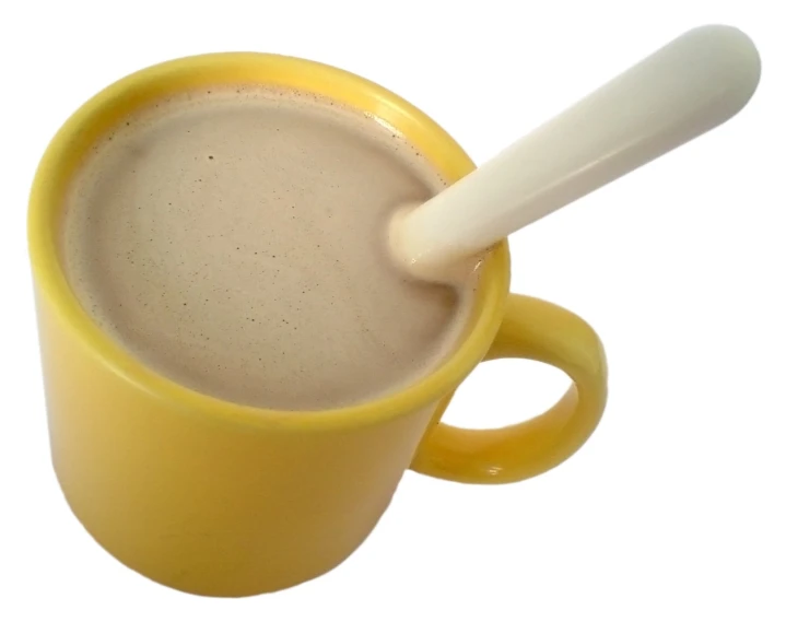 the mug of coffee has a white spoon sticking out of it