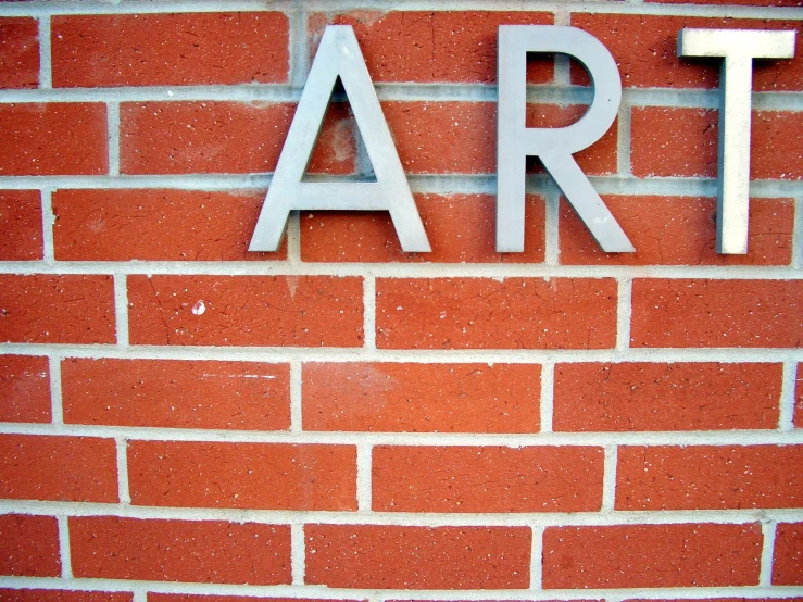 the letters art are painted on a brick wall