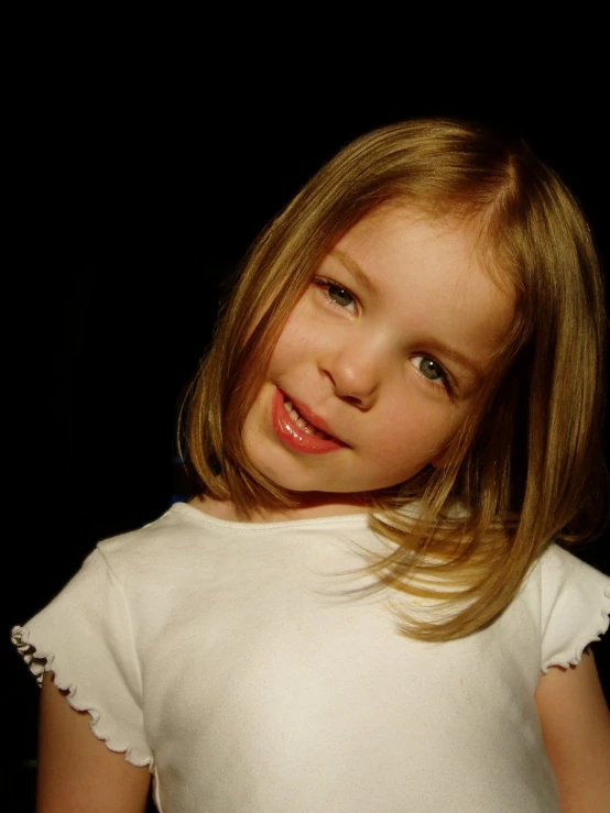 little girl smiling for picture while posing for picture