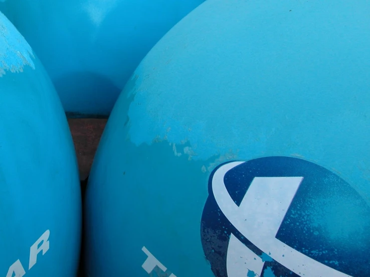 blue water pipes in the shape of giant blue balls with arrows on them