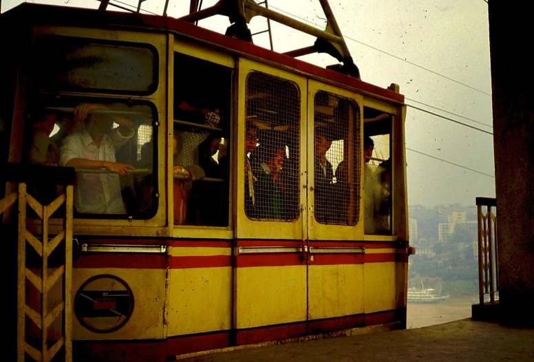 a city trolley with passengers sits on the track