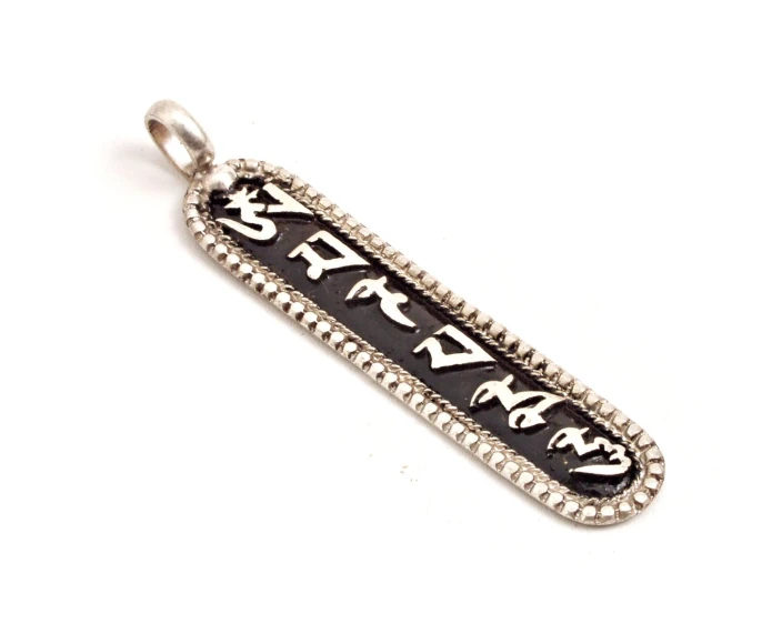 a silver pendant with the word peace in black on a white background