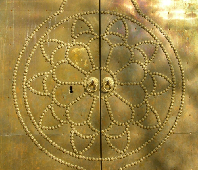 the two circles of gold are carved onto metal