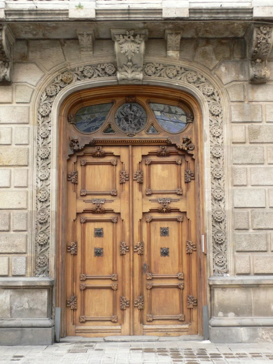 an ornate brown wooden door is on the front of a building