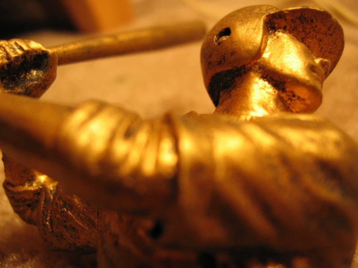 some gold statues sitting on a table in front of a camera