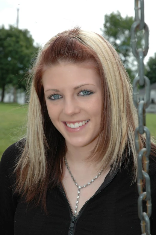 a woman standing next to a metal chain