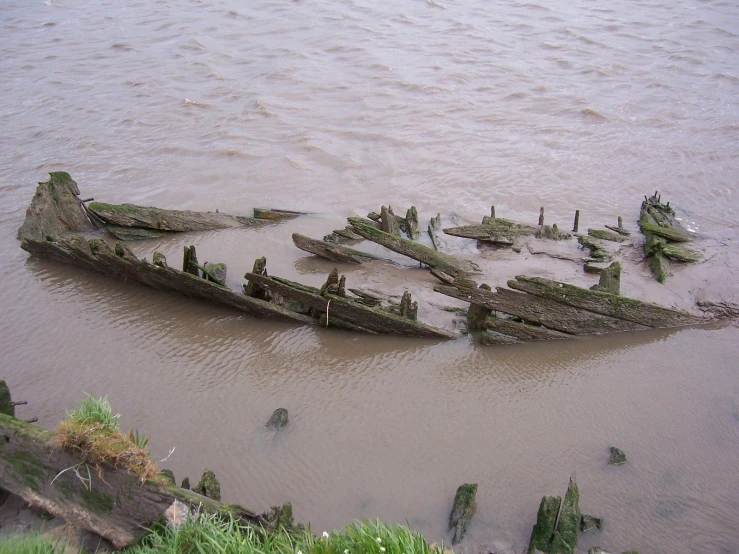 the remains of several ships are sitting in shallow waters