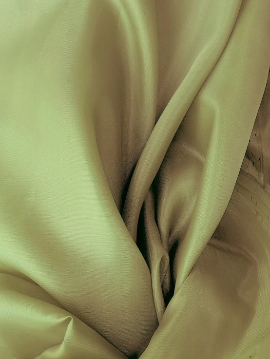 a close up of a green cloth with folds