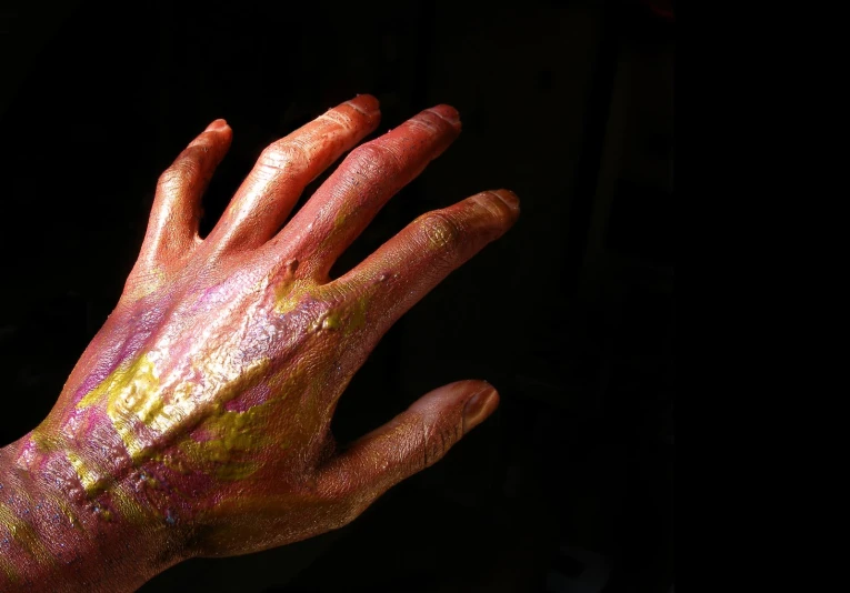 a person is covered in gold and pink paint