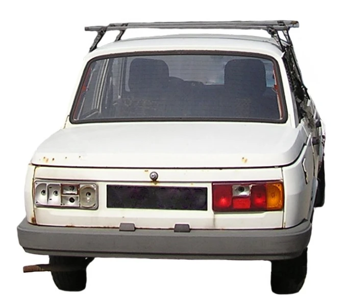 a white car with metal frame and skis on top