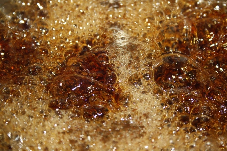 closeup of gold and brown liquid in water