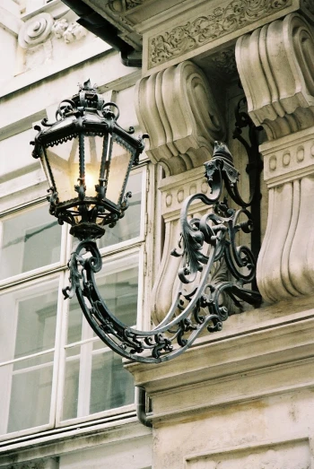 the lamp is hanging on the outside of the building