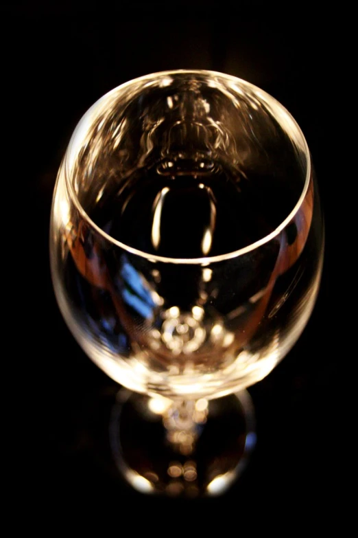 a clear bowl is sitting on a black background