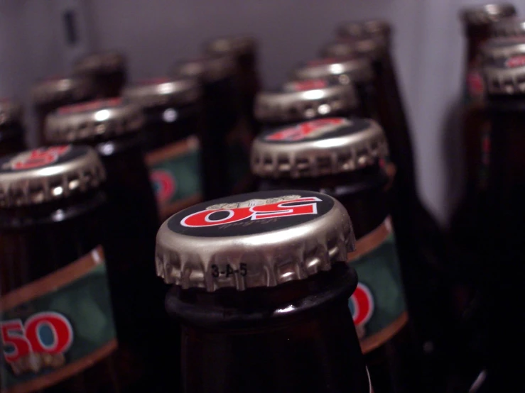 several rows of beer bottles stacked in a row