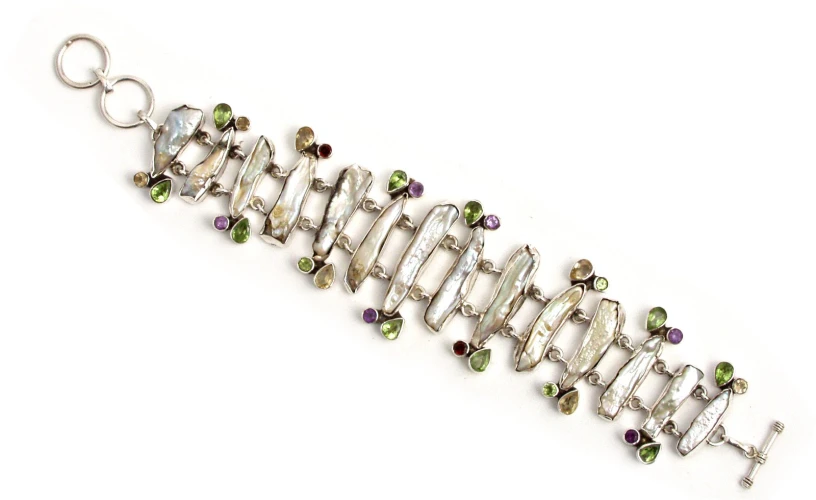 a silver wire celet with colored stones and other charms
