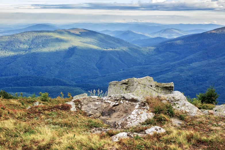 mountain scenery with rocks and grass at the base