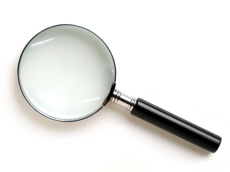 a magnifying glass on a white table