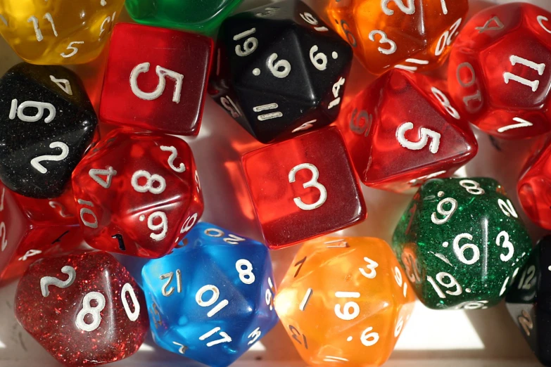 many color poly dice sitting on a table