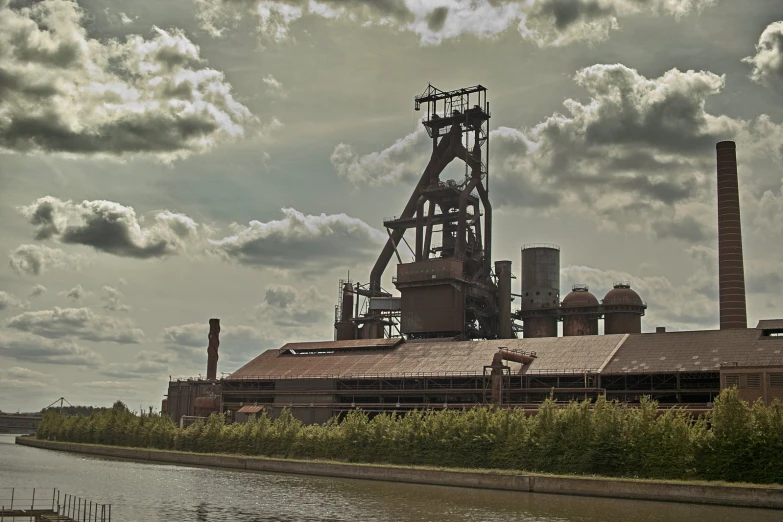 industrial architecture in front of an open - air setting near a river