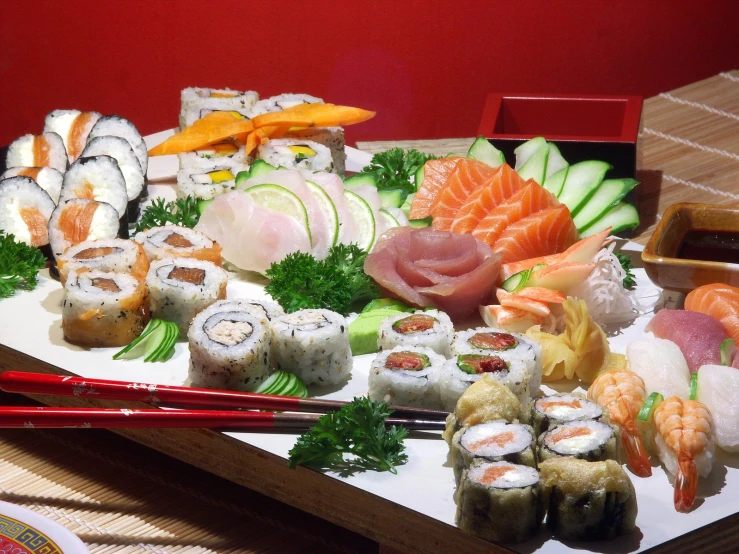 an array of sushi on a white plate