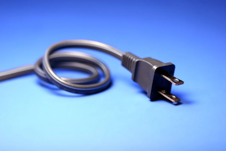 a computer cable that is on a blue surface