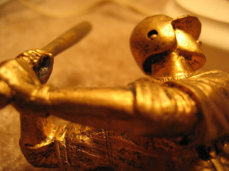 golden metal figurine depicting a baseball player